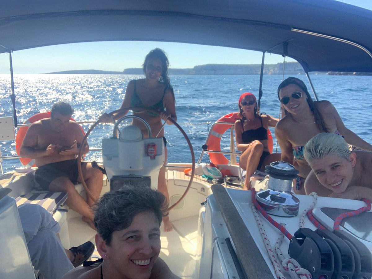 Paseando por la playa en un velero en Menorca