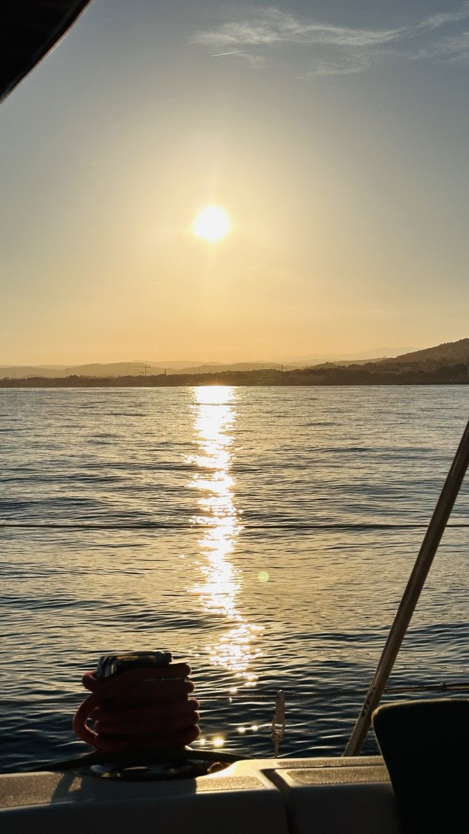 An orange and red sunset from the sailboat