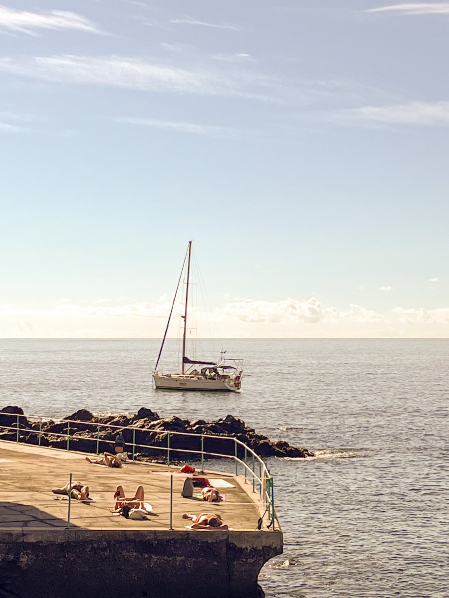 The boat sailing through the blue sea