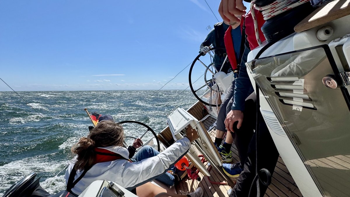 A picture of the boat crew celebrating the success of their 300 nautical mile trip in Tenerife