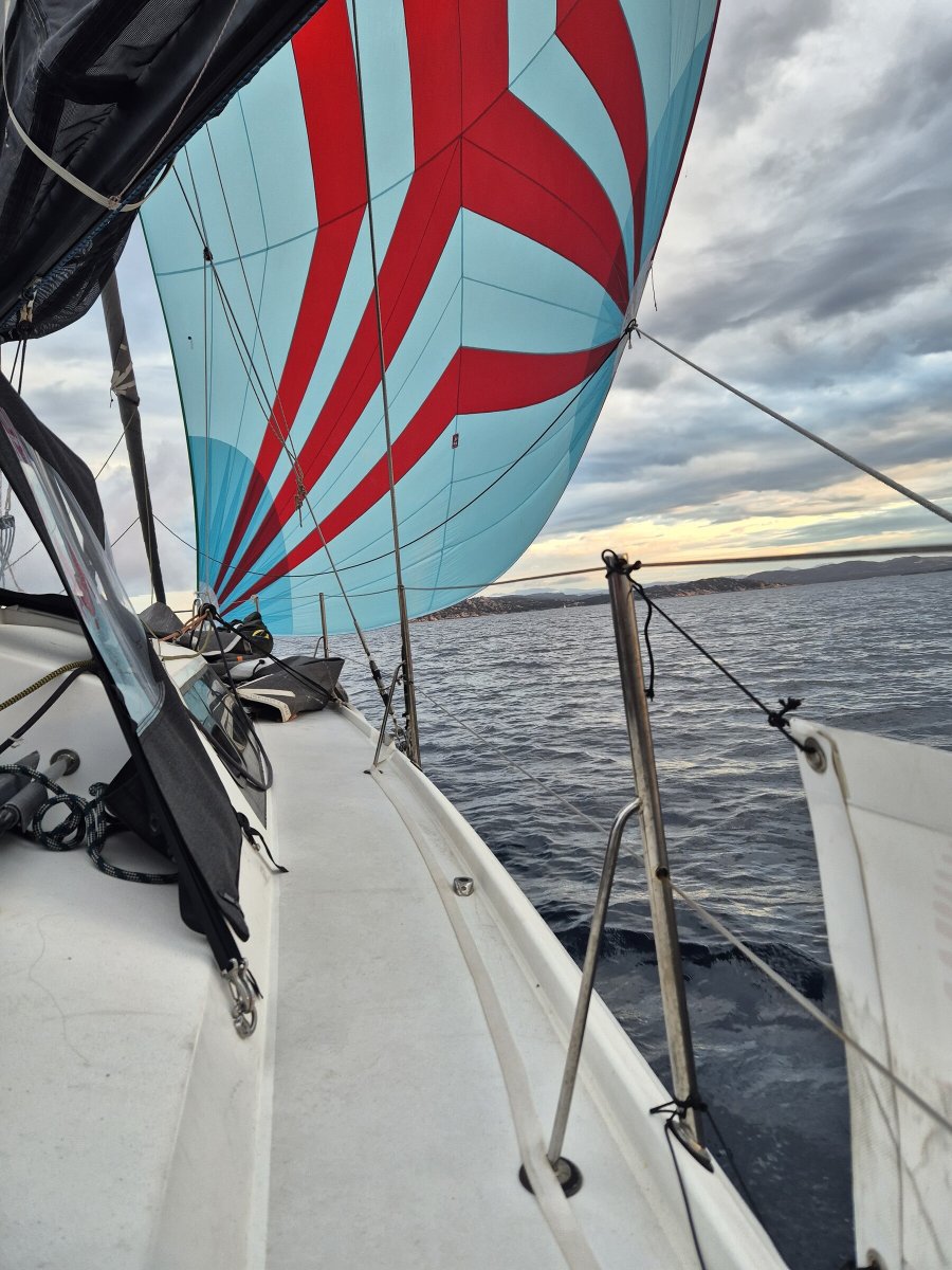 A person readies to sail on a boat