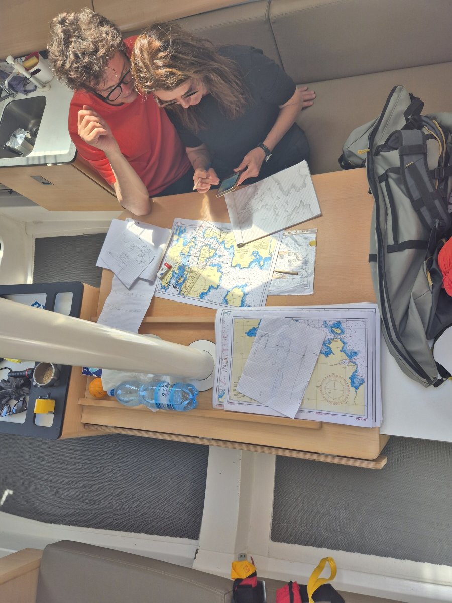 A person readies to sail on a boat