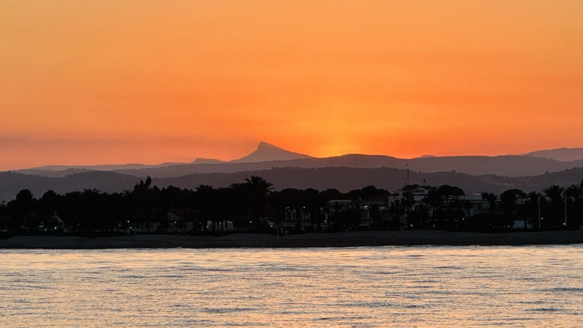 A sailboat sailing through the blue sea