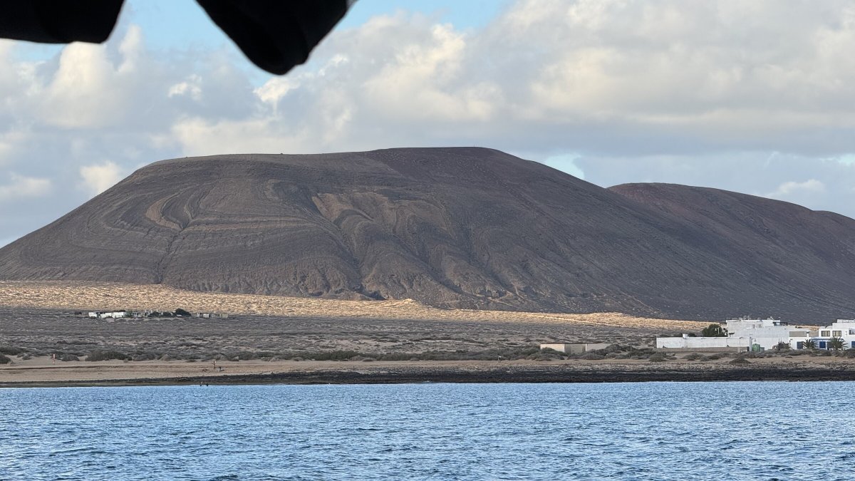 A panoramic view of the mountains and sea in Tenerife during a 300 nautical mile trip