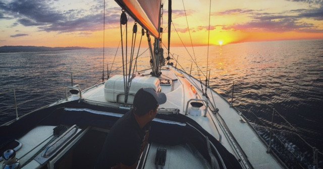 A sailboat on the sea during sunset